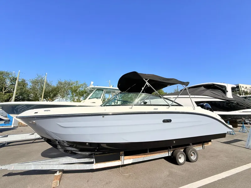 Slide: The Image of A 2026 Sea Ray SDX 250 Outboard on a trailer under a clear sky. - 1