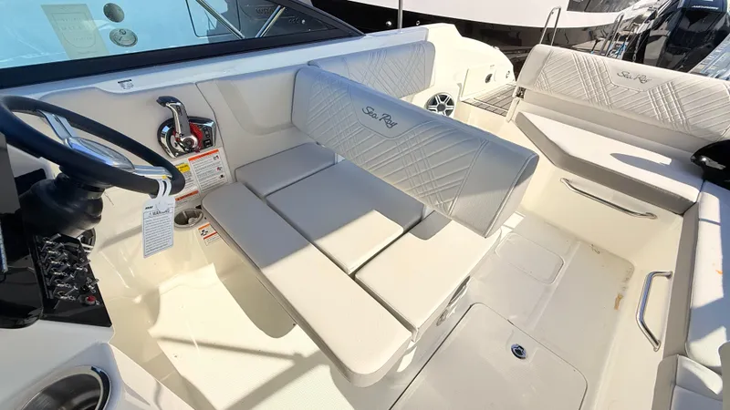 Slide: The Image of Interior of a Sea Ray SDX 250 Outboard with white upholstery and steering console. - 29