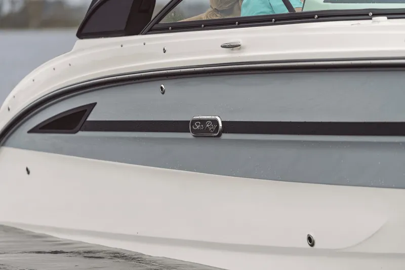 Slide: The Image of Close-up of the side of a Sea Ray SDX 270 Surf boat on the water. - 34