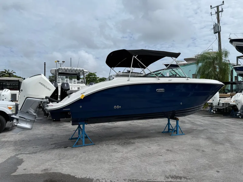 Slide: The Image of A 2026 Sea Ray SDX 250 Outboard on stands. It features a blue hull design. - 2