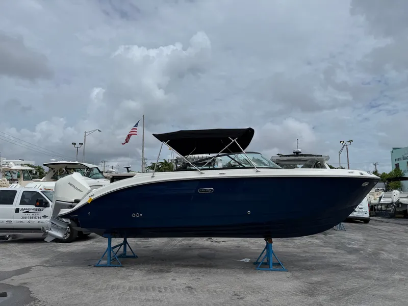 Slide: The Image of A 2026 Sea Ray SDX 250 Outboard on stands. It features a blue hull design. - 1