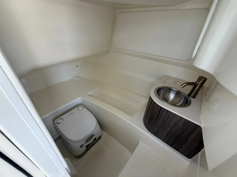 Slide: The Image of Interior view of a boat cabin with a toilet and sink. - 13