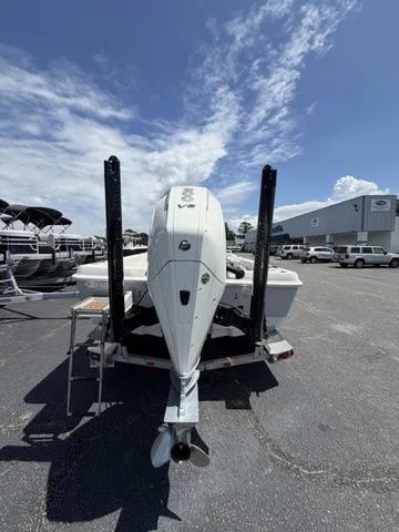 Slide: The Image of A 2025 Ranger 2360 Bay boat on a trailer in a parking lot. - 3