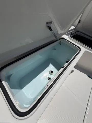 Slide: The Image of An open storage compartment on a boat with a white interior. - 12