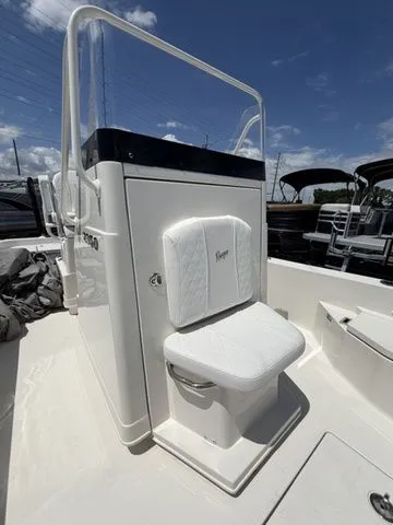 Slide: The Image of The image shows the helm of a Ranger 2360 Bay boat with a white seat. - 15
