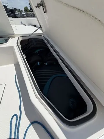 Slide: The Image of An open storage compartment on a boat with ropes and gear. - 13