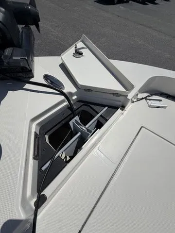 Slide: The Image of An open storage compartment on a boat with a mirror and an engine in the background. - 8