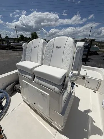 Slide: The Image of Two white cushioned seats on a boat with a blue sky in the background. - 19