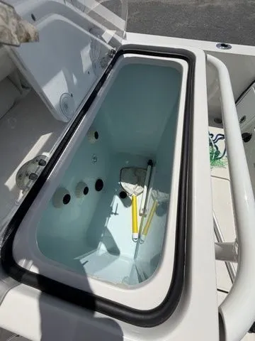 Slide: The Image of An open storage compartment on a boat with some items inside. - 22
