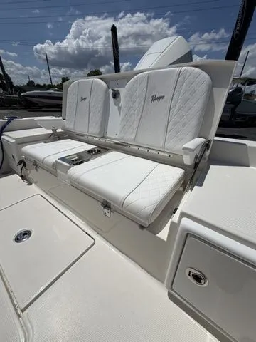 Slide: The Image of The 2025 Ranger 2360 Bay features a luxurious, cushioned bench seat with white upholstery. - 26