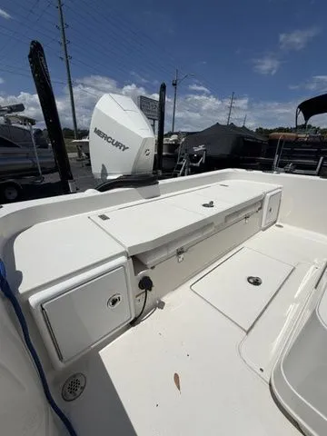 Slide: The Image of The image shows the deck of a 2025 Ranger 2360 Bay boat with a Mercury engine. - 24