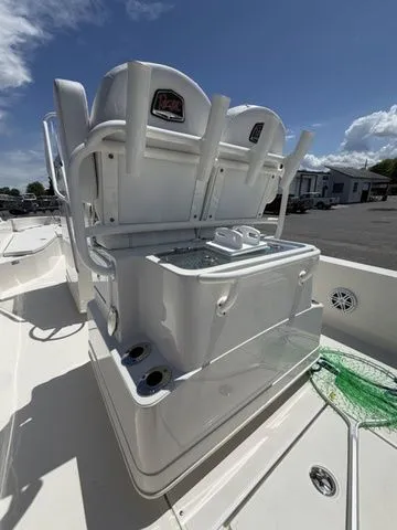 Slide: The Image of The image shows the cockpit of a 2025 Ranger 2360 Bay boat with seating and fishing rod holders. - 21