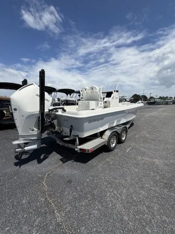 Slide: The Image of A 2025 Ranger 2360 Bay boat on a trailer in a parking lot. - 2