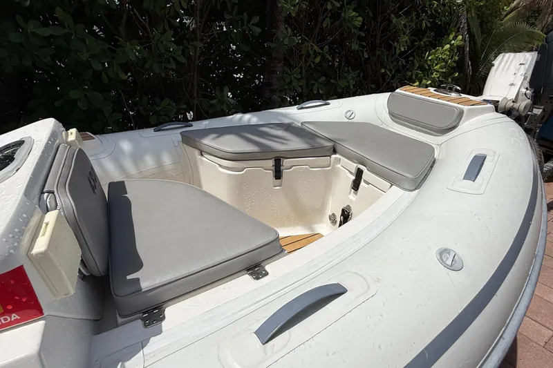 Slide: The Image of 2022 AB Inflatables ABJET 430XP boat with cushioned seating and sleek design. - 13