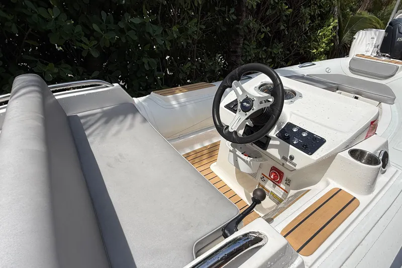 Slide: The Image of 2022 AB Inflatables ABJET 430XP boat interior with steering wheel and seating. - 12