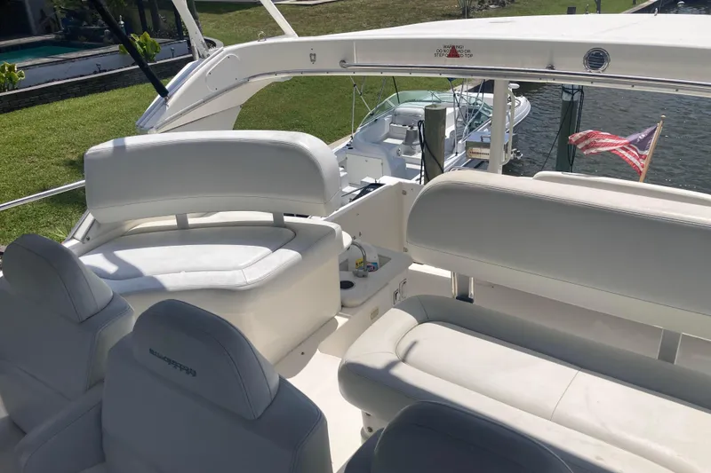 Slide: The Image of 2002 Silverton 39 Motor Yacht interior with white seating and American flag in background. - 7