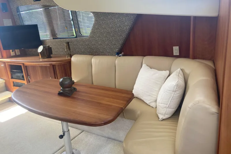 Slide: The Image of Interior of 2002 Silverton 39 Motor Yacht with cozy seating and wooden table. - 16