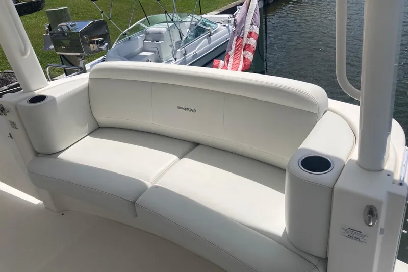 Slide: The Image of White seating area on a 2002 Silverton 39 Motor Yacht, featuring cup holders. - 9