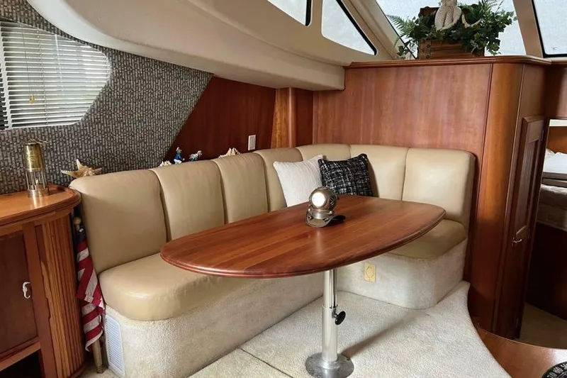 Slide: The Image of Interior of 2002 Silverton 39 Motor Yacht with elegant seating and wooden table. - 14