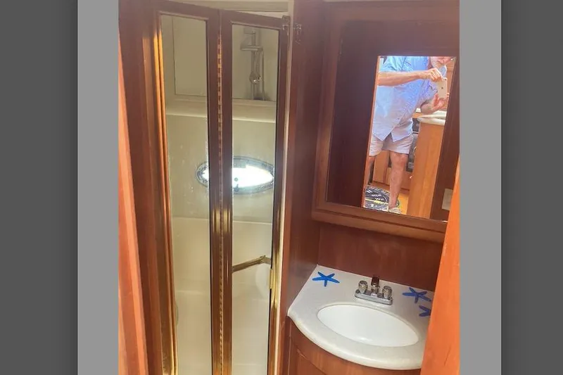 Slide: The Image of Interior of 2002 Silverton 39 Motor Yacht bathroom with shower and sink. - 25
