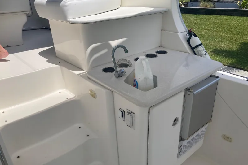 Slide: The Image of 2002 Silverton 39 Motor Yacht deck with sink, seating, and fire extinguisher. - 11