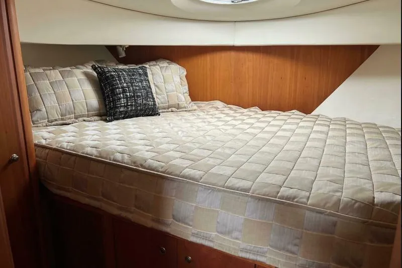 Slide: The Image of Luxurious bedroom interior of 2002 Silverton 39 Motor Yacht with cozy bedding. - 23