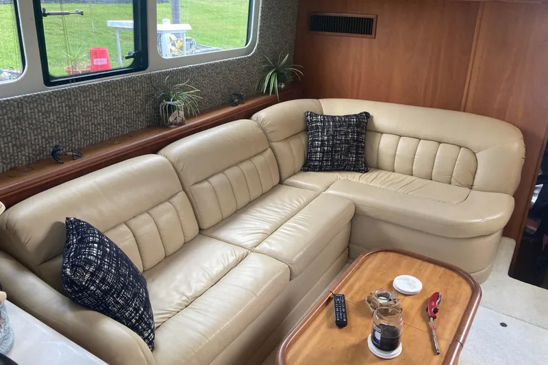 Slide: The Image of Luxurious interior of 2002 Silverton 39 Motor Yacht with beige leather seating and wooden accents. - 15