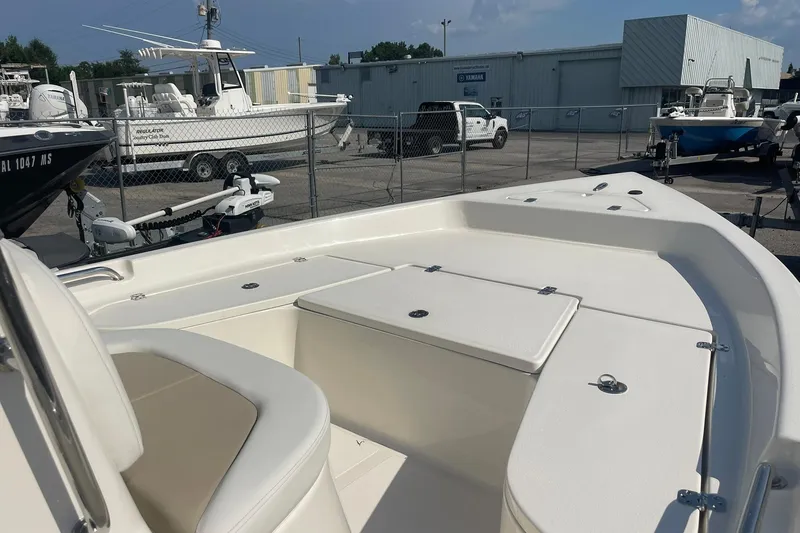 Slide: The Image of 2026 Bulls Bay 2000 boat interior with seating and storage, parked in a marina. - 4