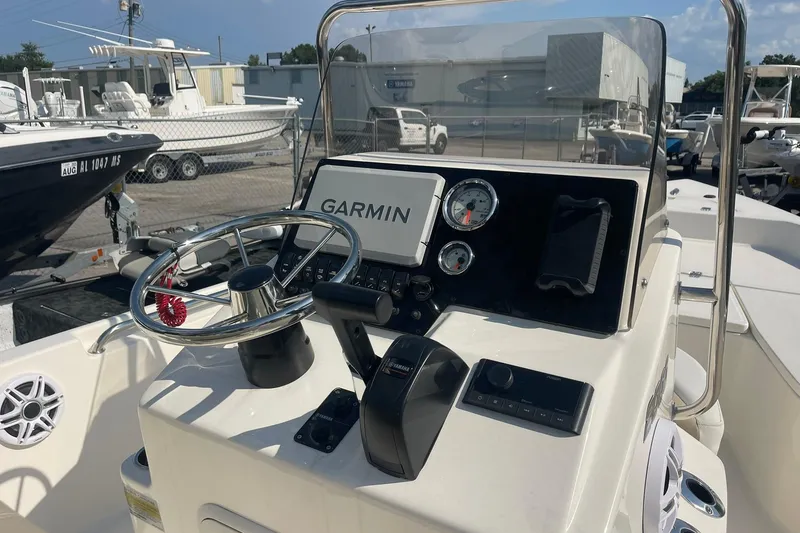 Slide: The Image of 2026 Bulls Bay 2000 boat console with Garmin navigation, steering wheel, and gauges. - 2