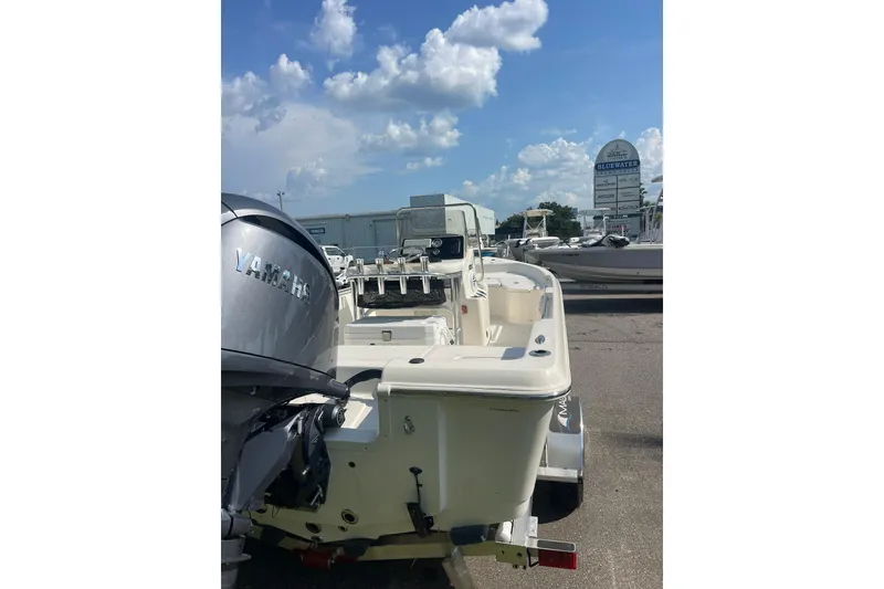 Slide: The Image of 2026 Bulls Bay 2000 boat with Yamaha engine, parked outdoors under a cloudy sky. - 3