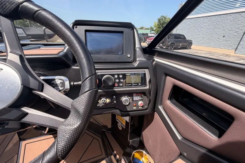 Slide: The Image of 2019 Moomba Makai dashboard with steering wheel, control panel, and touchscreen display. - 16
