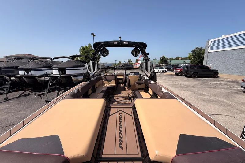 Slide: The Image of 2019 Moomba Makai boat with tan seating, parked outdoors in a dealership lot. - 23