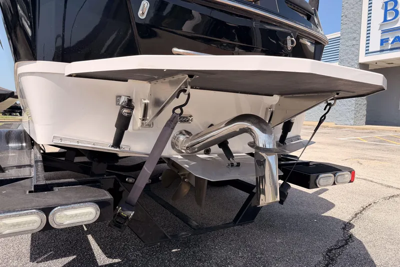Slide: The Image of Rear view of a 2019 Moomba Makai boat on a trailer, showcasing the exhaust and swim platform. - 37