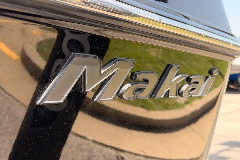 Slide: The Image of Close-up of 2019 Moomba Makai logo on a shiny black surface. - 27