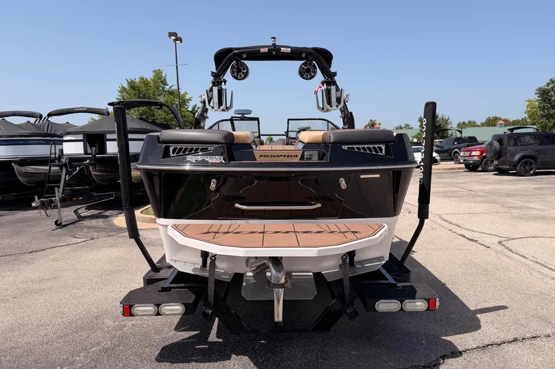 Slide: The Image of 2019 Moomba Makai boat rear view in a parking lot, showcasing sleek design and features. - 7