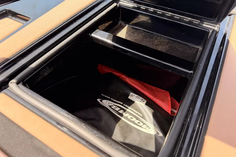 Slide: The Image of Storage compartment in a 2019 Moomba Makai boat with branded gear inside. - 35