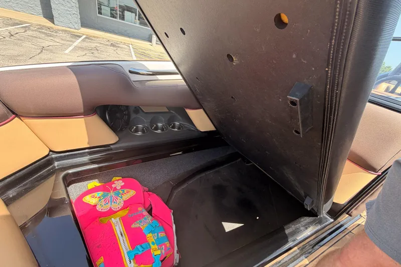 Slide: The Image of 2019 Moomba Makai boat storage compartment with colorful bag inside. - 12