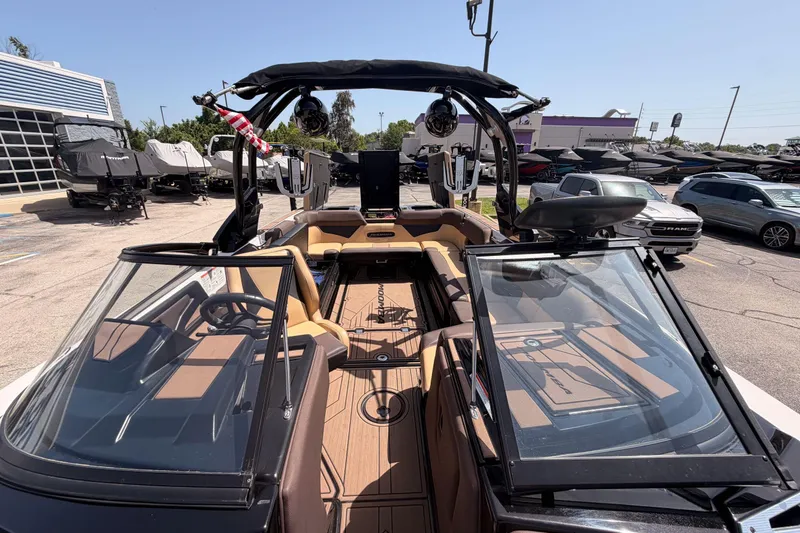 Slide: The Image of 2019 Moomba Makai boat interior with sleek design and modern features, parked outdoors. - 13