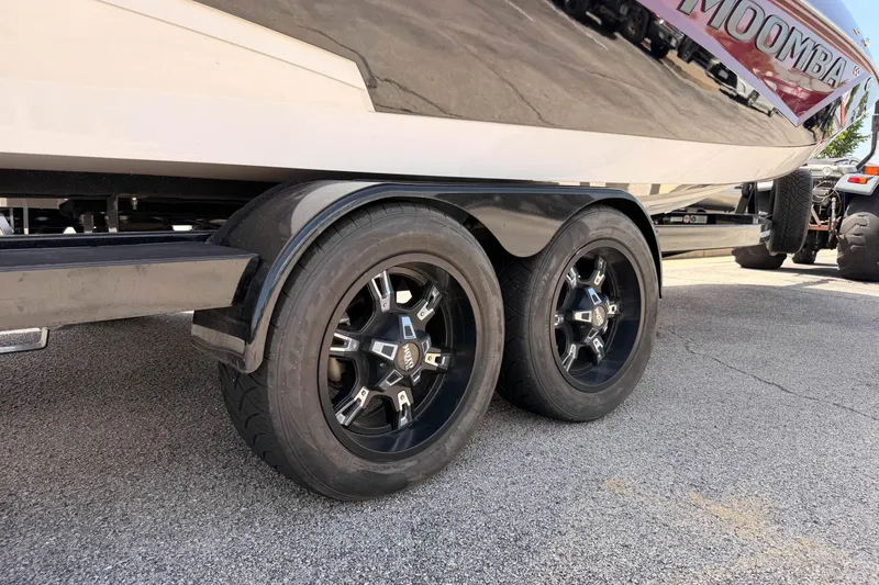 Slide: The Image of 2019 Moomba Makai boat trailer with black wheels on pavement. - 21