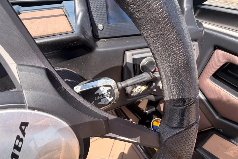 Slide: The Image of Steering wheel and controls of a 2019 Moomba Makai boat interior. - 15