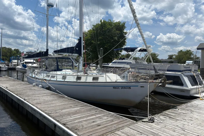 Slide: The Image of 1980 Gulfstar 50 CC Ketch sailboat docked at marina under cloudy sky. - 4