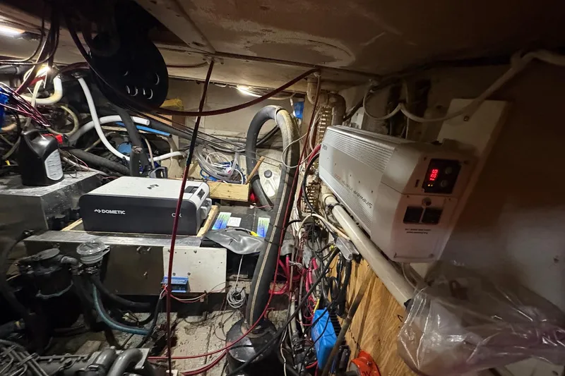 Slide: The Image of Engine room of a 1980 Gulfstar 50 CC Ketch with various equipment and wiring. - 48