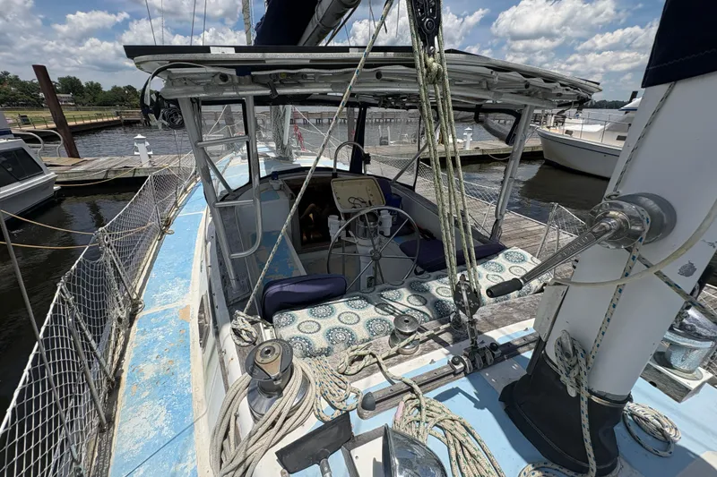 Slide: The Image of 1980 Gulfstar 50 CC Ketch sailboat docked, featuring a spacious cockpit and nautical decor. - 16