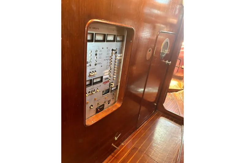 Slide: The Image of Control panel inside 1980 Gulfstar 50 CC Ketch, featuring wooden interior and electrical switches. - 28