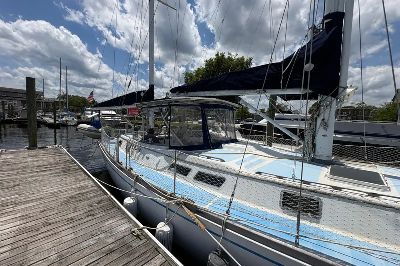Slide: The Image of 1980 Gulfstar 50 CC Ketch sailboat docked at marina under partly cloudy sky. - 7