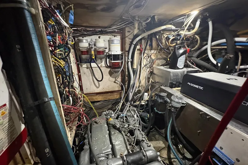 Slide: The Image of Engine room of a 1980 Gulfstar 50 CC Ketch, showcasing complex wiring and machinery. - 49