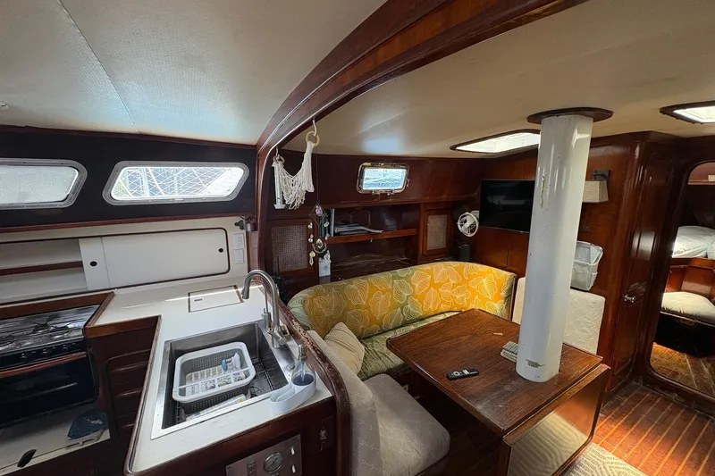 Slide: The Image of Interior of 1980 Gulfstar 50 CC Ketch with cozy seating and kitchen area. - 23