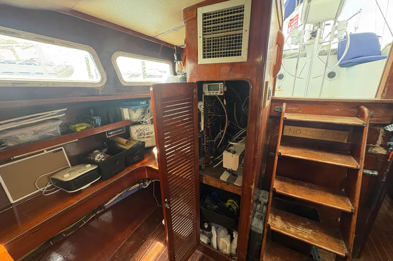 Slide: The Image of Interior of 1980 Gulfstar 50 CC Ketch with wooden cabinetry and storage shelves. - 20