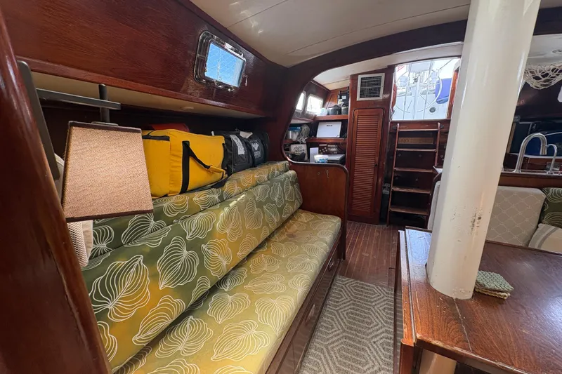Slide: The Image of Interior of 1980 Gulfstar 50 CC Ketch with patterned cushions and wooden finishes. - 18