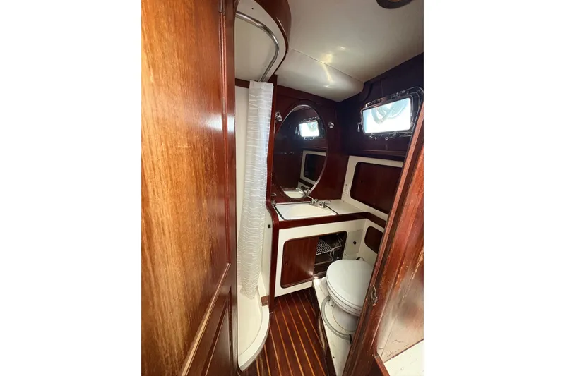 Slide: The Image of Interior of 1980 Gulfstar 50 CC Ketch bathroom with wood paneling and nautical fixtures. - 36